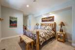 Experience rustic charm in this inviting bedroom, featuring a cozy log bed adorned with wildlife-themed bedding.