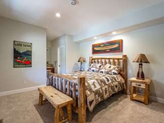 Experience rustic charm in this inviting bedroom, featuring a cozy log bed adorned with wildlife-themed bedding.
