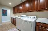 This spacious laundry room features a convenient side-by-side washer and dryer set, perfect for handling large loads.