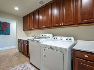 This spacious laundry room features a convenient side-by-side washer and dryer set, perfect for handling large loads.