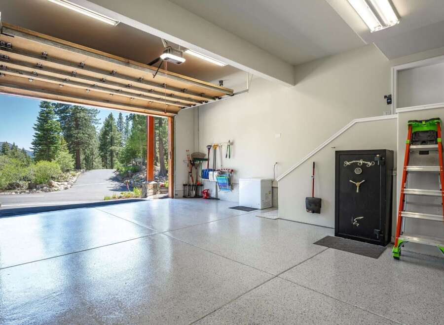 Discover this spacious garage featuring a pristine epoxy-coated floor, perfect for protecting your vehicles.