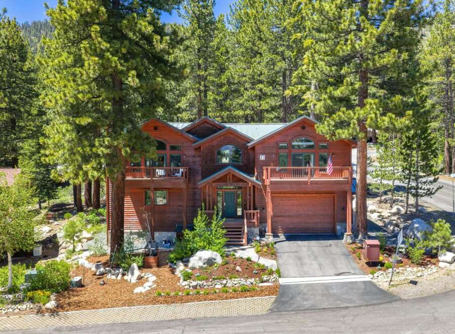 Nestled amidst towering pine trees, this stunning wooden mountain home offers a serene retreat.