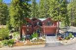 Nestled amidst towering pine trees, this stunning wooden mountain home offers a serene retreat.