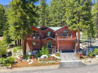 Nestled amidst towering pine trees, this stunning wooden mountain home offers a serene retreat.