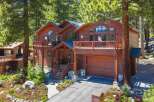 Nestled amongst tall pine trees, this stunning multi-level wooden home offers a picturesque retreat.