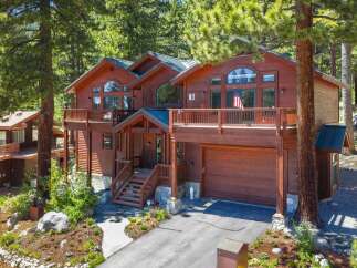 Nestled amongst tall pine trees, this stunning multi-level wooden home offers a picturesque retreat.