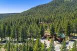 Nestled amidst a dense forest of towering pine trees, this property offers a serene mountain retreat.