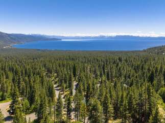 Experience breathtaking panoramic views of Lake Tahoe and the surrounding snow-capped mountains from this stunning property.