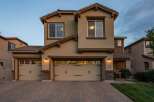 This stunning two-story home features a welcoming facade with a three-car garage and elegant stone accents.
