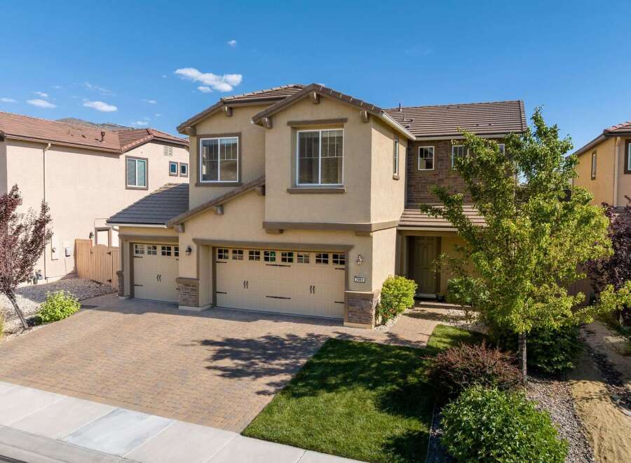 Discover this stunning two-story home featuring a spacious three-car garage and a beautifully paved driveway.