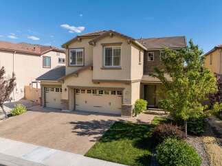 Discover this stunning two-story home featuring a spacious three-car garage and a beautifully paved driveway.