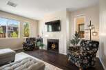 Cozy living room featuring a modern fireplace with a mounted television, perfect for relaxing evenings.