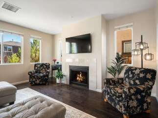 Cozy living room featuring a modern fireplace with a mounted television, perfect for relaxing evenings.