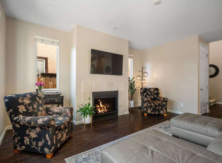 Cozy living room featuring a modern fireplace with a mounted television above, perfect for relaxing evenings.
