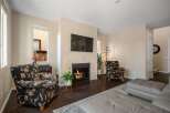 Cozy living room featuring a modern fireplace with a mounted television above, perfect for relaxing evenings.