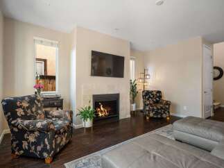 Cozy living room featuring a modern fireplace with a mounted television above, perfect for relaxing evenings.