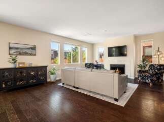 Step into this inviting living room, featuring a plush sofa and a cozy fireplace perfect for relaxing evenings.