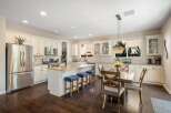 This spacious kitchen boasts a large island with seating, perfect for casual dining and entertaining.