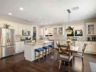 This spacious kitchen boasts a large island with seating, perfect for casual dining and entertaining.