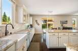 Experience the heart of this home with a spacious kitchen featuring a large farmhouse sink and granite countertops.