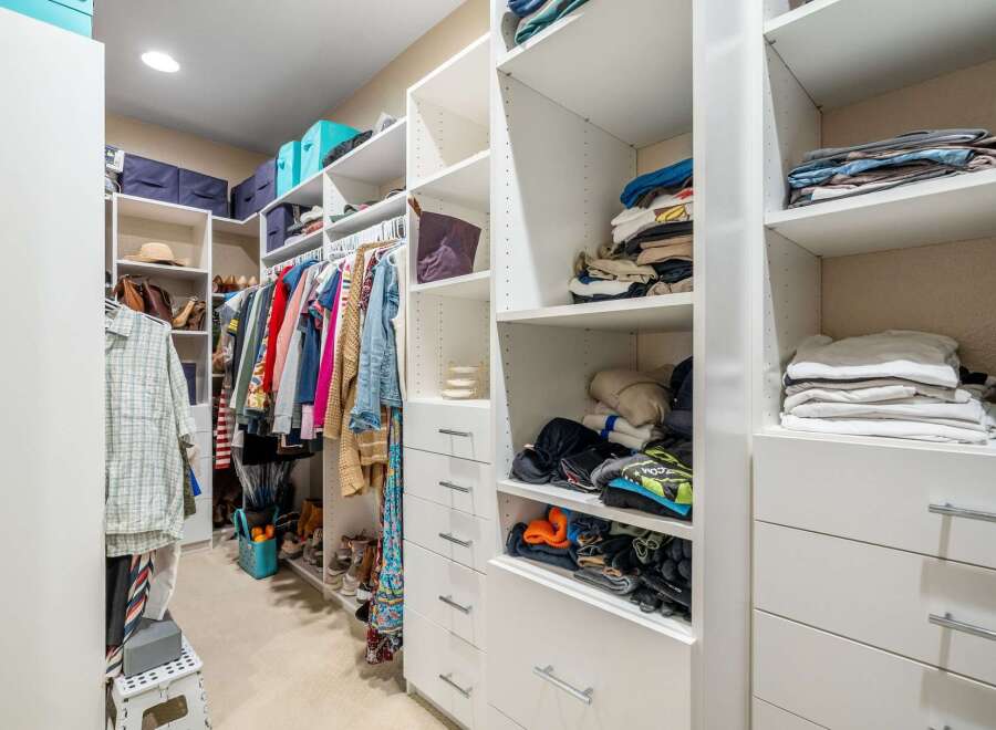 Discover an impeccably organized walk-in closet designed for modern living.