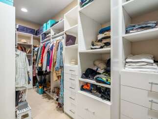 Discover an impeccably organized walk-in closet designed for modern living.