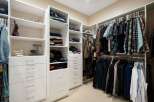 Discover organized luxury in this spacious walk-in closet, featuring ample shelving and drawers for all your clothing and accessories.