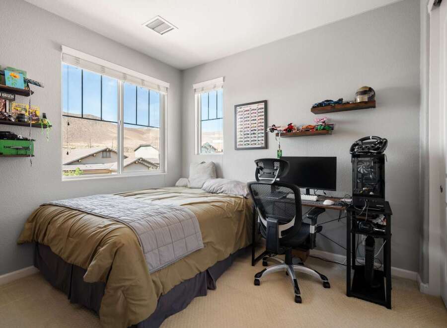 This bedroom offers a comfortable and functional space, perfect for relaxation and productivity.