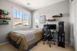 This bedroom offers a comfortable and functional space, perfect for relaxation and productivity.