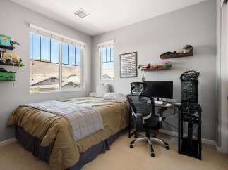 This bedroom offers a comfortable and functional space, perfect for relaxation and productivity.