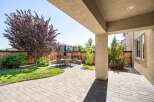 Enjoy outdoor living in this beautifully landscaped backyard featuring a spacious paver patio perfect for entertaining.