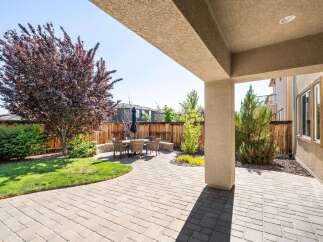 Enjoy outdoor living in this beautifully landscaped backyard featuring a spacious paver patio perfect for entertaining.