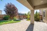 Enjoy outdoor living in this beautifully landscaped backyard featuring a spacious paver patio perfect for entertaining.