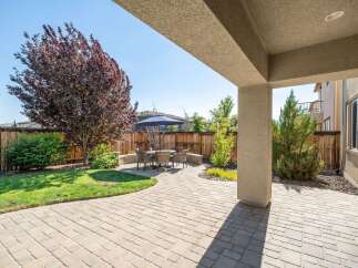 Enjoy outdoor living in this beautifully landscaped backyard featuring a spacious paver patio perfect for entertaining.