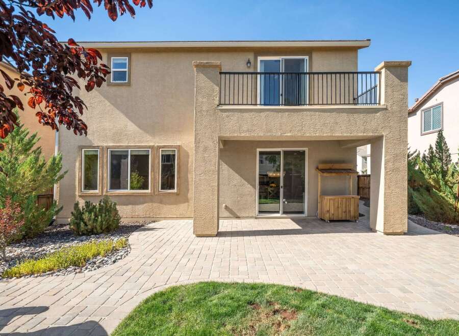 Enjoy outdoor living with this spacious backyard featuring a paved patio and a covered entertainment area.
