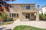 Enjoy outdoor living with this spacious backyard featuring a paved patio and a covered entertainment area.