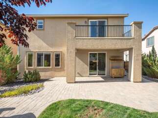 Enjoy outdoor living with this spacious backyard featuring a paved patio and a covered entertainment area.