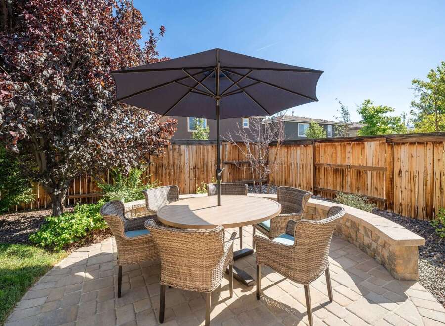 Enjoy outdoor living in this charming backyard featuring a paved patio area perfect for entertaining.