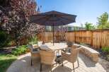 Enjoy outdoor living in this charming backyard featuring a paved patio area perfect for entertaining.