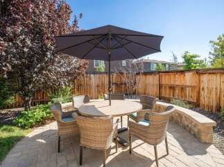 Enjoy outdoor living in this charming backyard featuring a paved patio area perfect for entertaining.