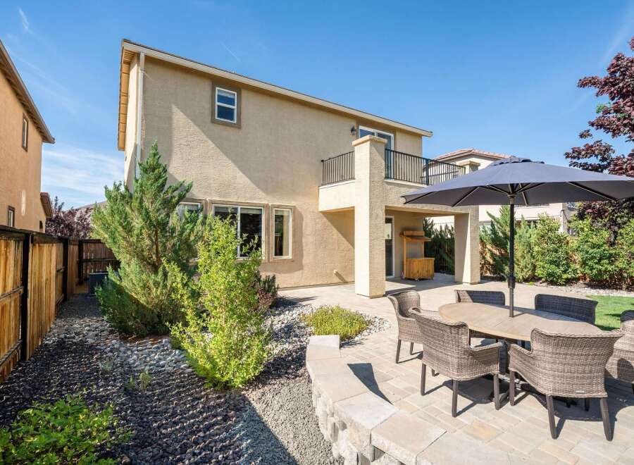 Enjoy outdoor living in this spacious backyard featuring a paved patio area perfect for entertaining.
