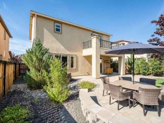 Enjoy outdoor living in this spacious backyard featuring a paved patio area perfect for entertaining.