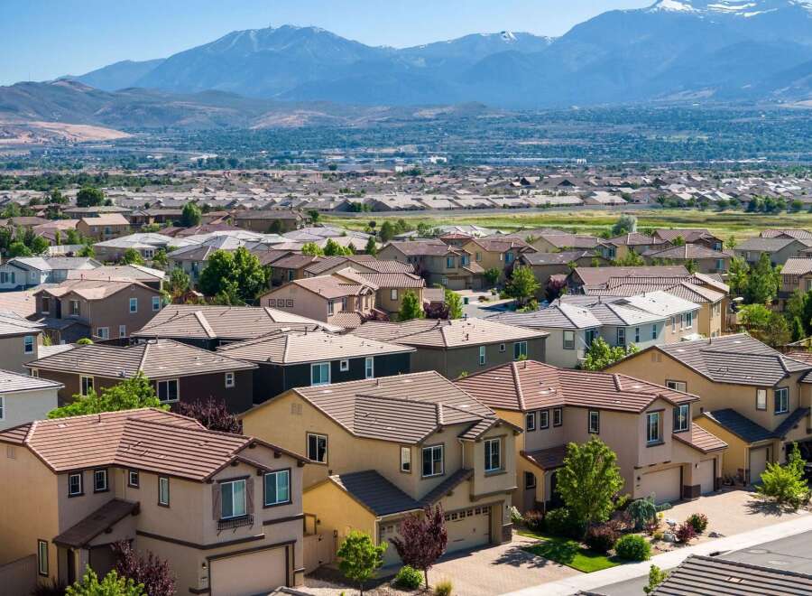 Discover this expansive suburban neighborhood with a stunning mountain backdrop, offering a variety of modern homes with tile roofs and well-maintained landscaping.