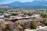Discover this expansive suburban neighborhood with a stunning mountain backdrop, offering a variety of modern homes with tile roofs and well-maintained landscaping.