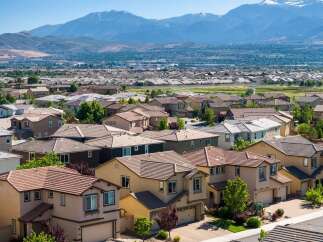 Discover this expansive suburban neighborhood with a stunning mountain backdrop, offering a variety of modern homes with tile roofs and well-maintained landscaping.