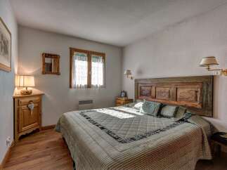 Experience rustic charm in this cozy bedroom, featuring a unique reclaimed wood headboard that adds character and warmth.
