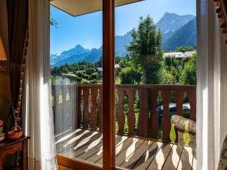 Experience breathtaking mountain views from this charming property, featuring a private balcony perfect for enjoying the alpine scenery.