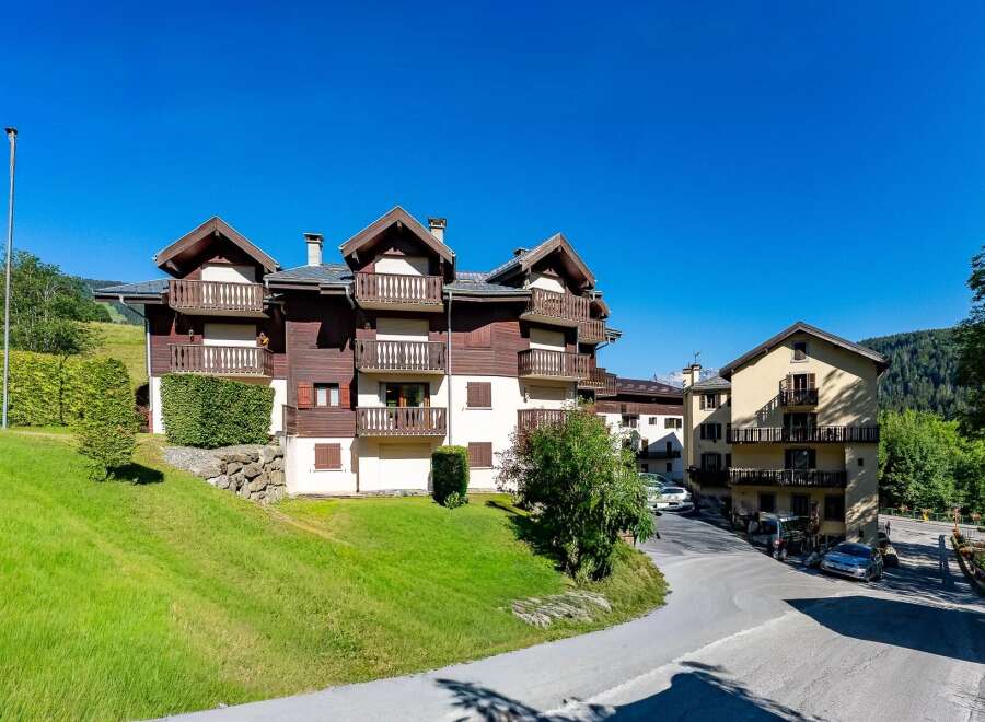 Experience alpine living in this charming property featuring traditional wooden architecture and multiple balconies offering scenic views.
