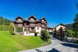 Experience alpine living in this charming property featuring traditional wooden architecture and multiple balconies offering scenic views.