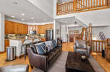 Experience rustic charm in this spacious living area, featuring a gourmet kitchen with rich wood cabinetry and granite countertops, perfect for entertaining.